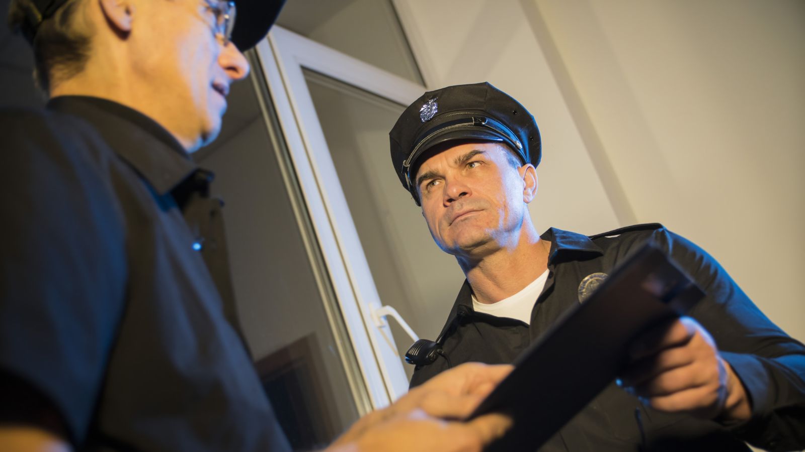 Man talking to a cop and they both look annoyed