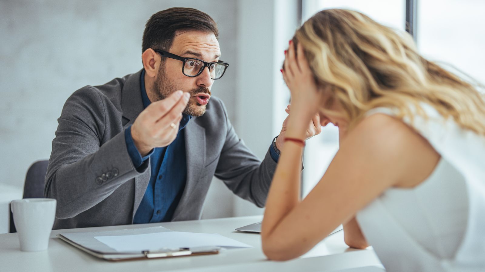 Male boss upsetting female employee