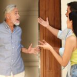 Neighbors yelling at each other in a doorway