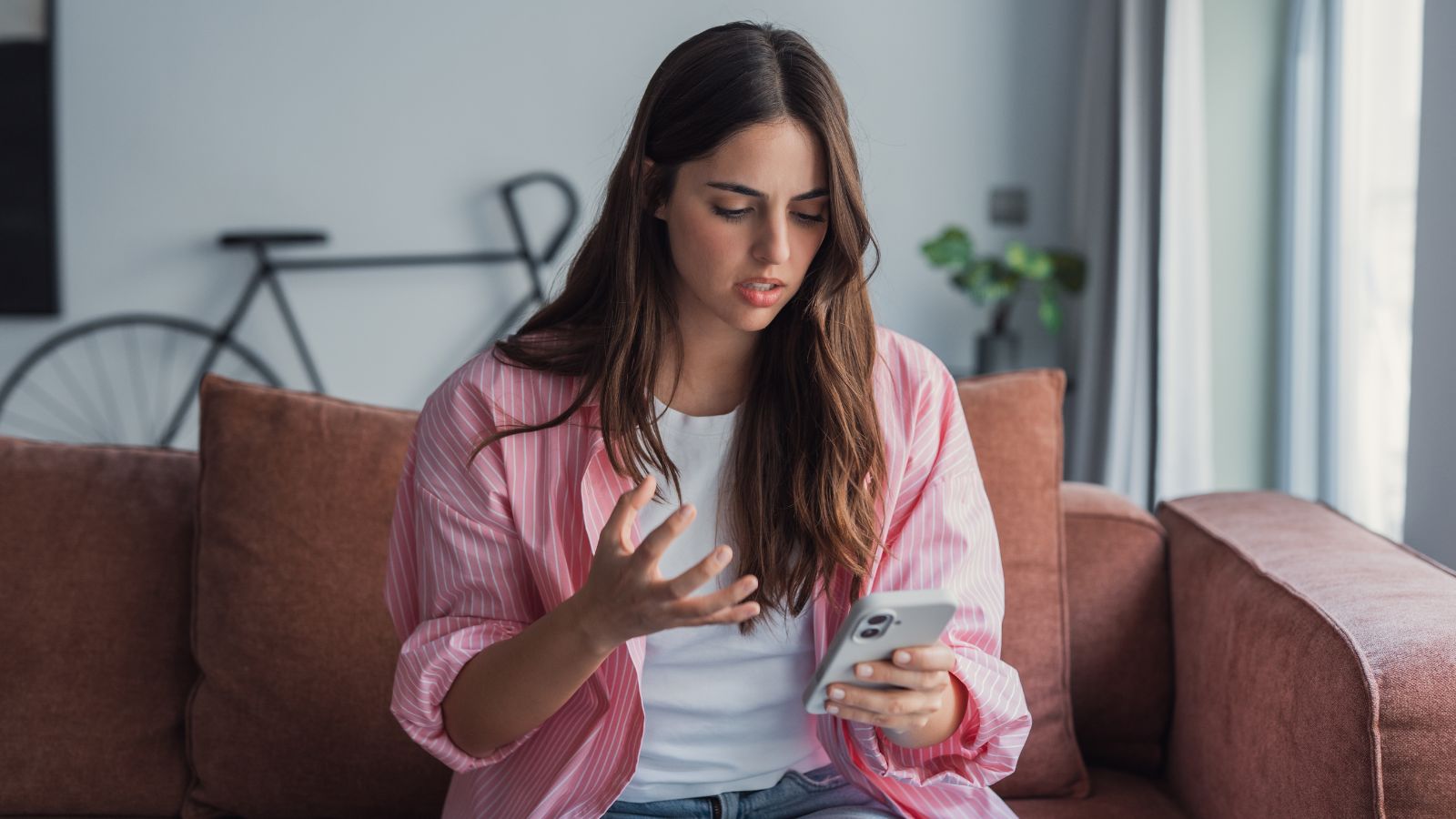 Woman looking upset at her phone