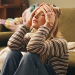 Woman holding her head and looking frustrated