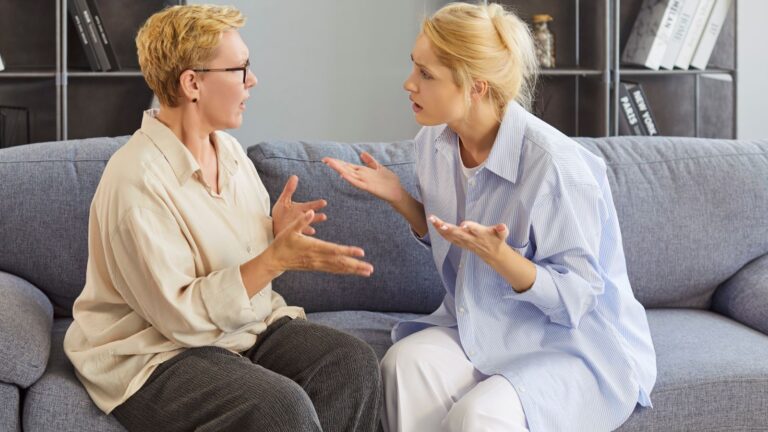 Woman and mother arguing on couch