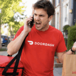 DoorDash delivery person carrying bags and looking angry on the phone