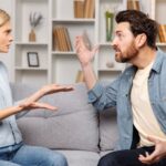 Adult siblings arguing on the couch