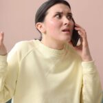 Woman looking angry with her phone at her ear