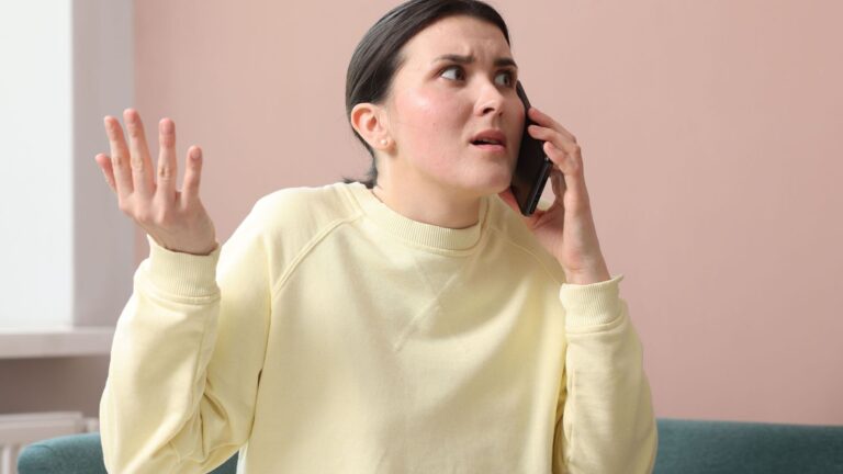 Woman looking angry with her phone at her ear