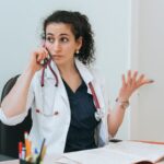 Medical professional talking on the phone and looking annoyed