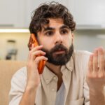 Man talking on the phone and looking very annoyed