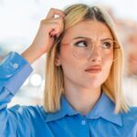 Blonde woman scratching her head