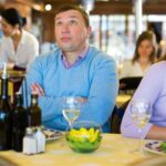 Couple sitting at a restaurant appearing to be in a fight