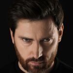Angry looking man all in black
