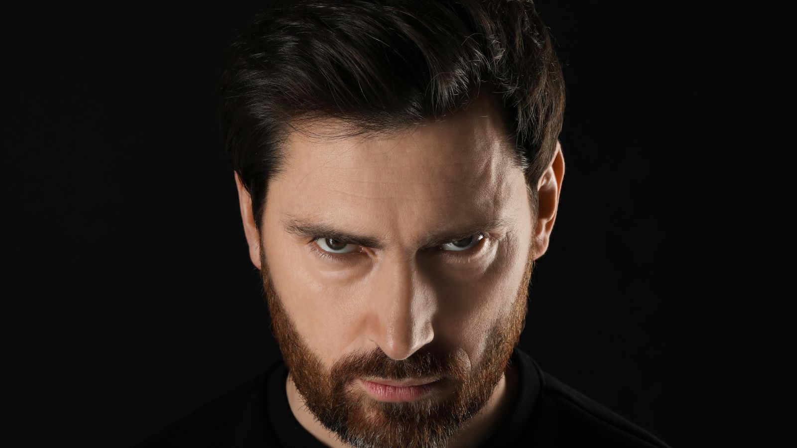 Angry looking man all in black