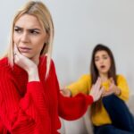 Women sitting on the couch arguing