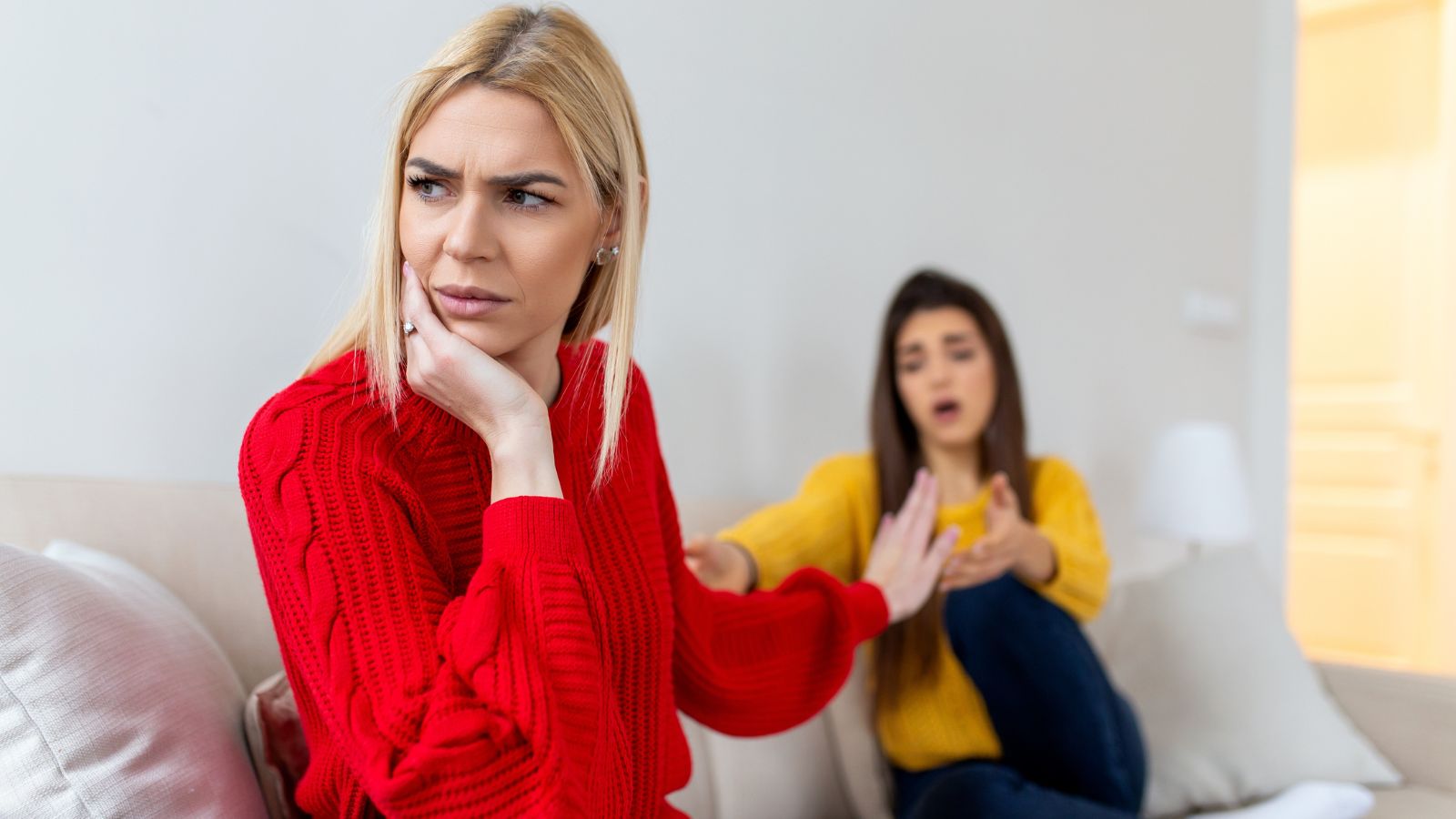 Women sitting on the couch arguing
