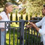 Woman and man arguing over a fence