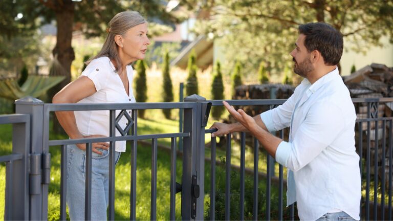 Woman and man arguing over a fence