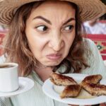 Woman looking judgy at a plate of food