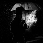 Man walking with an umbrella in the dark