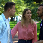 Two men arguing with a woman standing in between