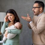 Husband angry with wife holding baby
