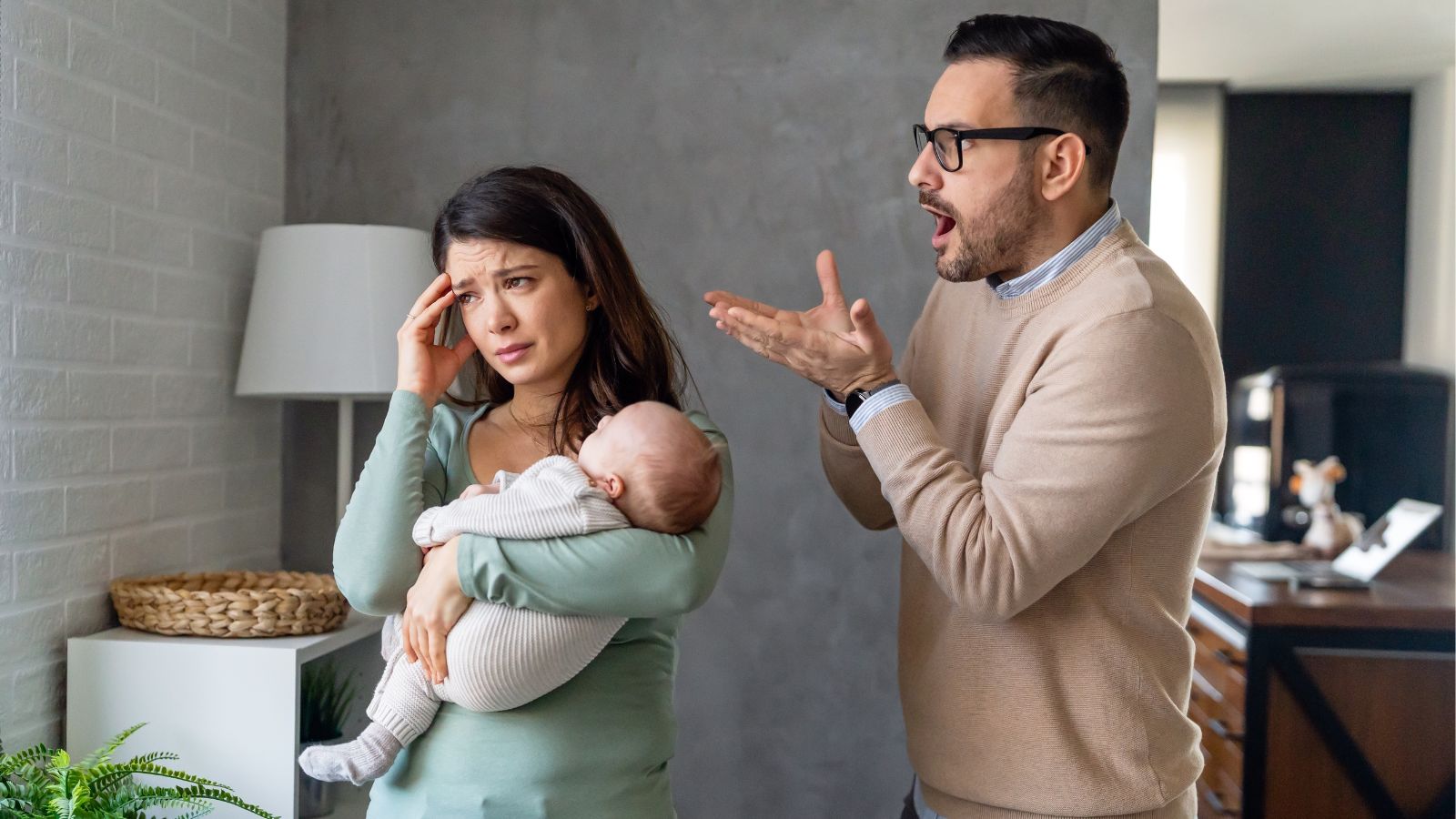 Husband angry with wife holding baby