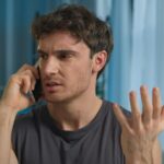 Young man talking on the phone looking angry