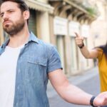 Couple arguing outside in an alleyway