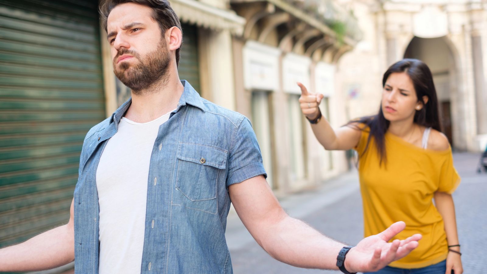 Couple arguing outside in an alleyway