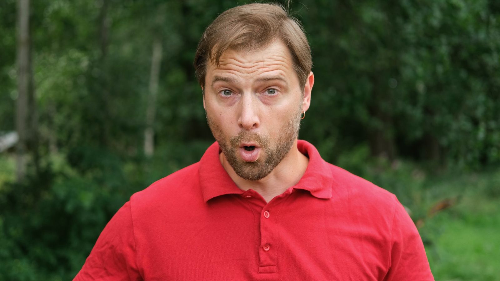 Man standing outside with a shocked look on his face