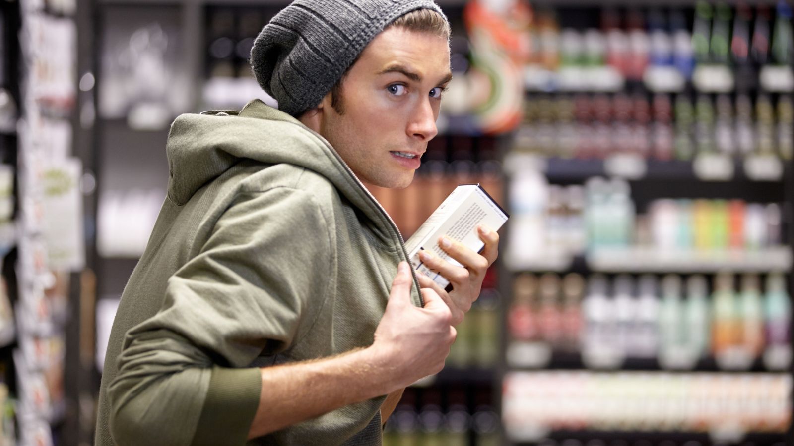 Young man shoplifting in a store