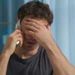 Man on phone looking upset