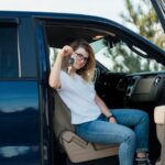 Woman sitting in truck holding keys