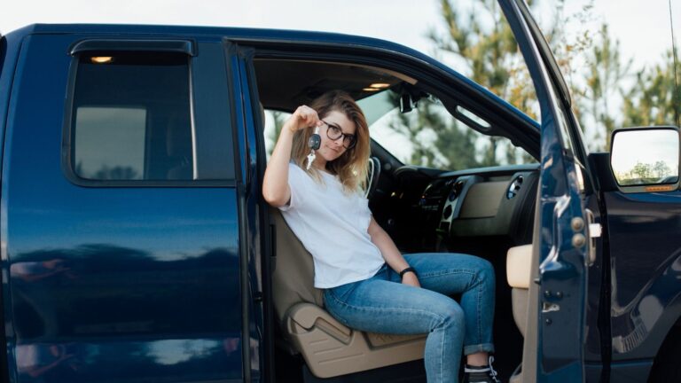 Woman sitting in truck holding keys