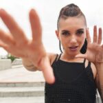 Woman with tattoos holding her hands out