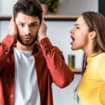 Woman yelling at a man in his ear