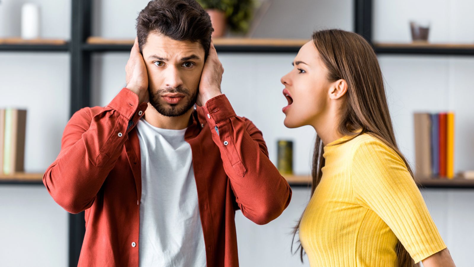 Woman yelling at a man in his ear