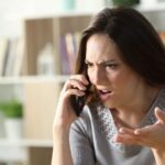 Woman looking very angry while on the phone