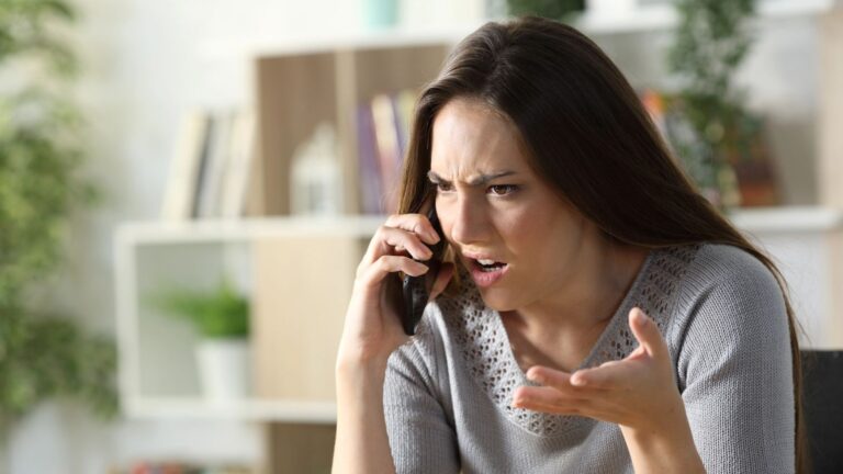 Woman looking very angry while on the phone