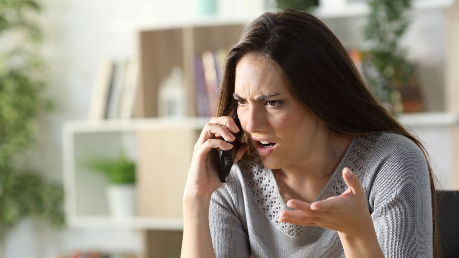 Woman looking very angry while on the phone